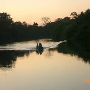 Belize River with men on boat – Best Places In The World To Retire – International Living